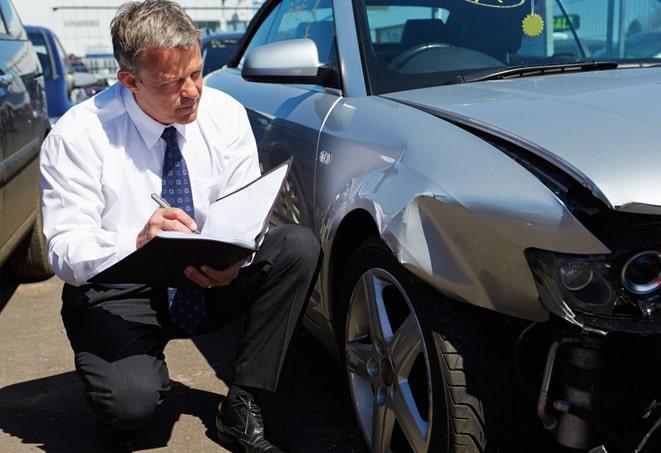 black car parked with insurance coverage displayed