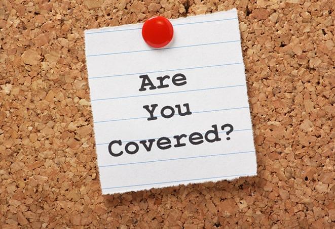 insurance agent discussing coverage options with motorcycle owner in Hudson